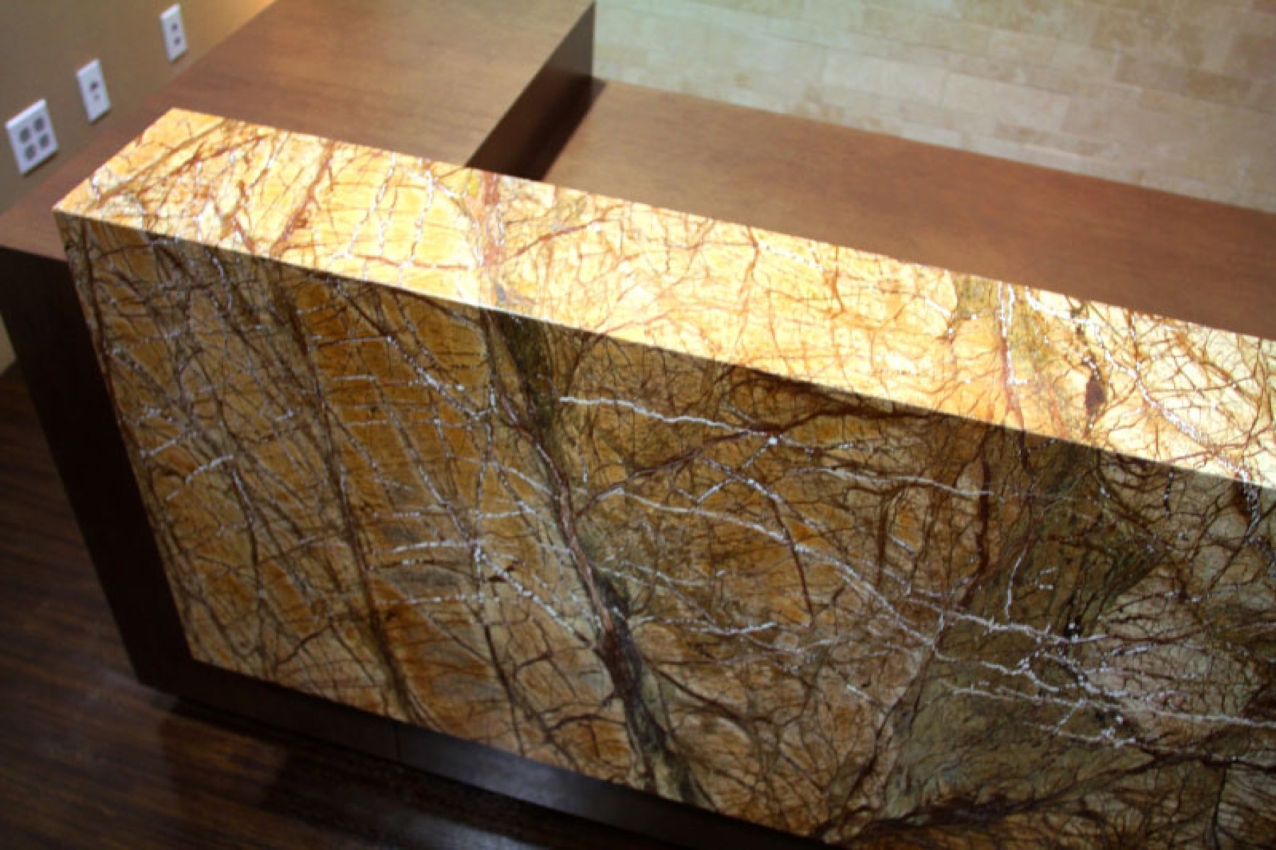 Custom stone reception desk fabricated for a millwork and cabinetry client
