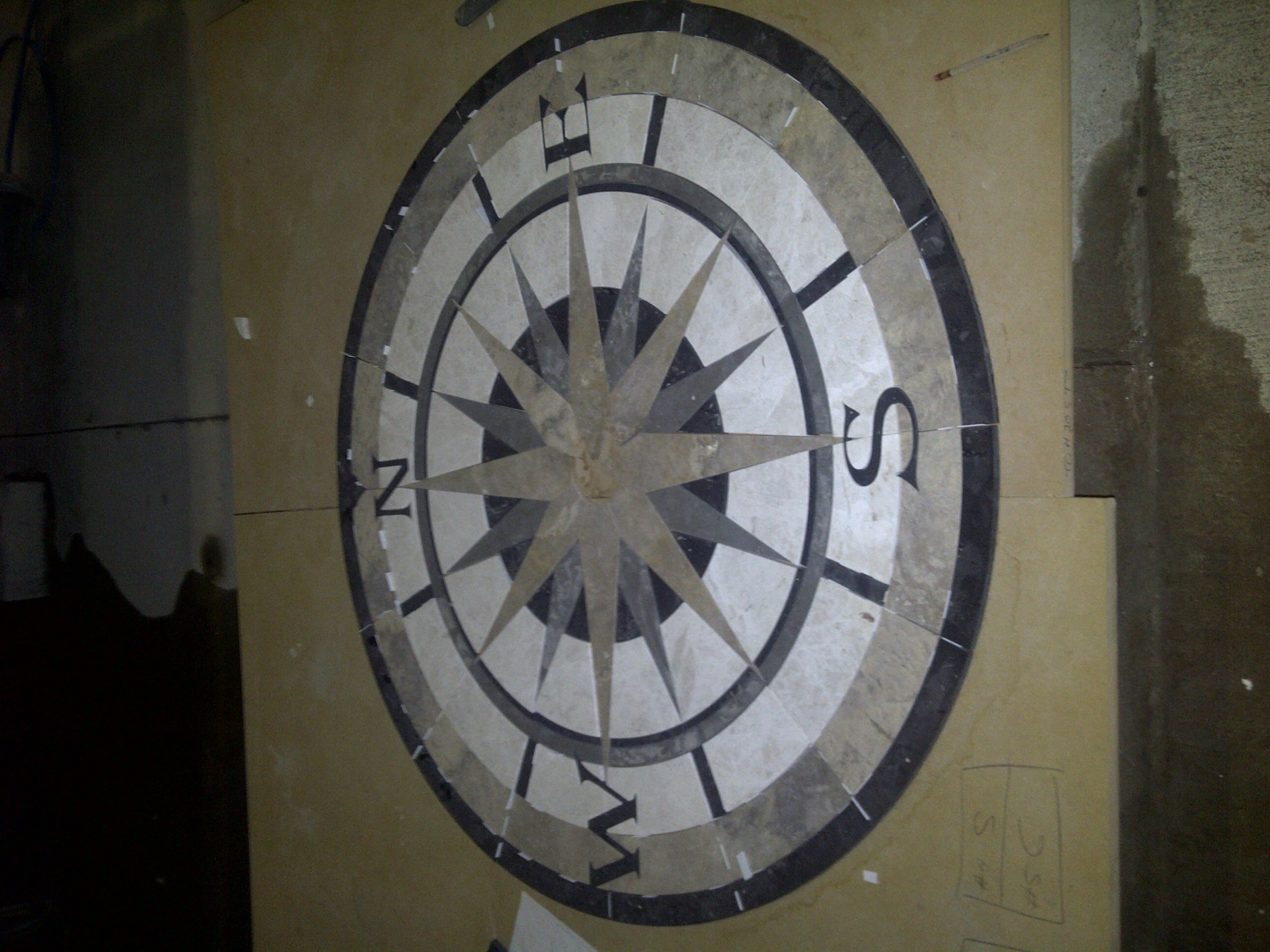 Custom stone floor medallion fabricated and installed by Cangelosi Company