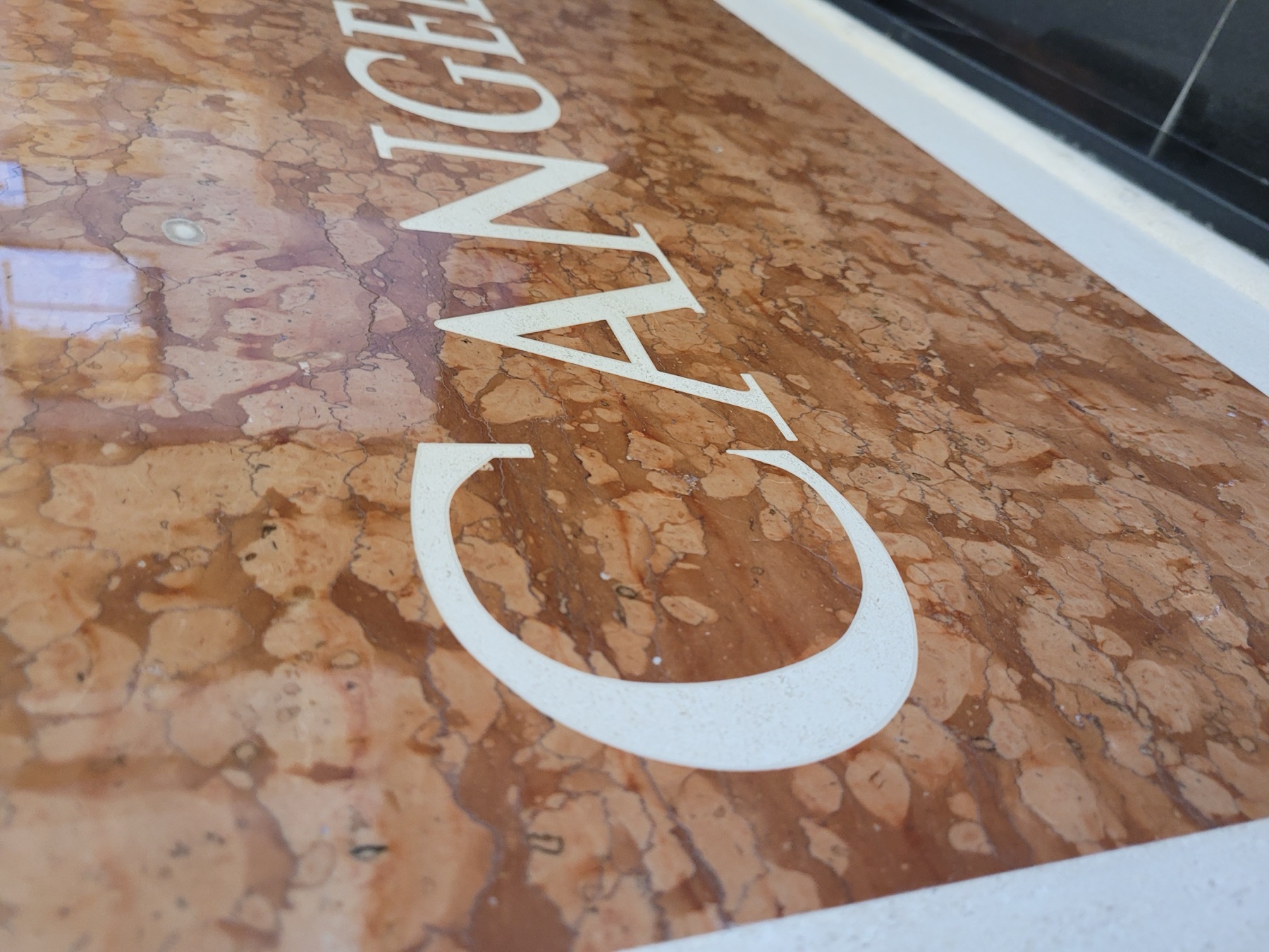 Waterjet-cut lettering detail in natural stone fabricated by Cangelosi Company